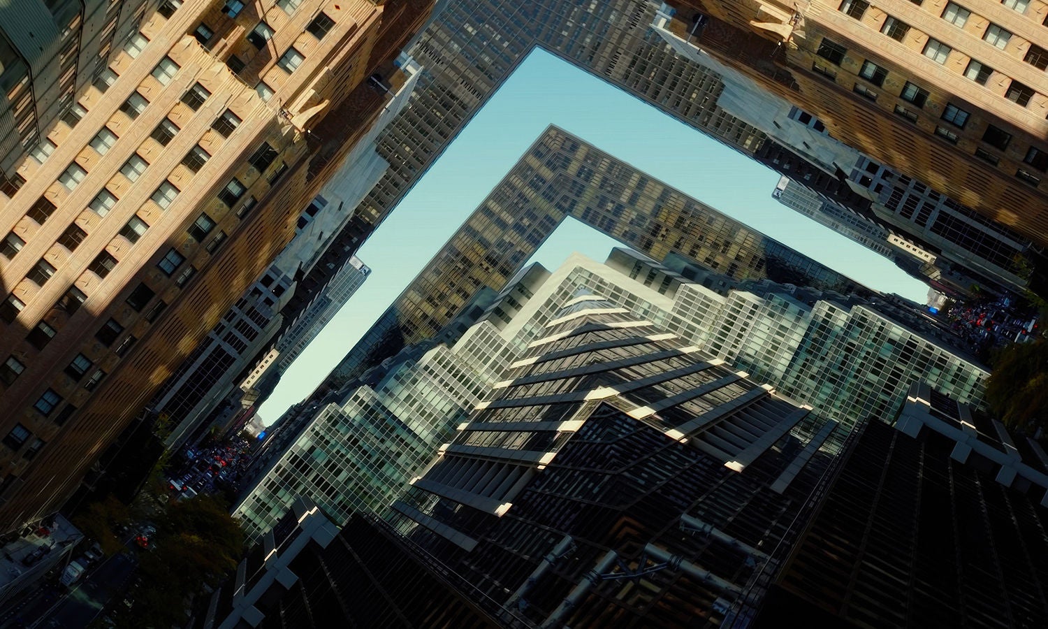 Aerial view of high-rise buildings forming an L-shaped gap and sharp skyline, highlighting urban density and geometry.​